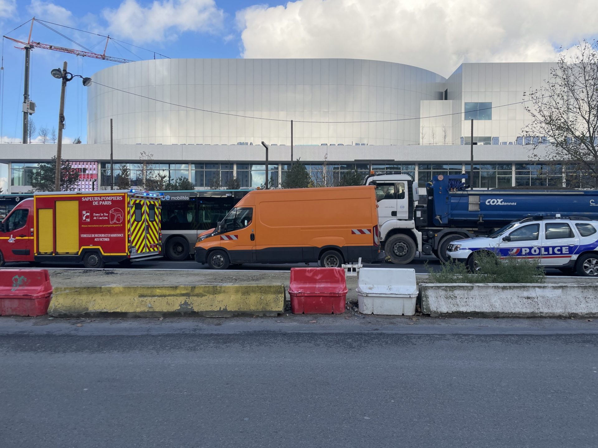 Colors, cars, problems and solutions, a tree, a piece of blue sky, an Arena.